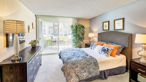 a bedroom with a bed and a sliding glass door